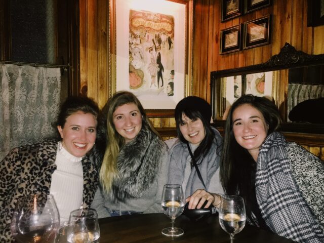 Monica Dimperio smiling with friends at the Sinatra table in 4 Charles Prime Rib Restaurant