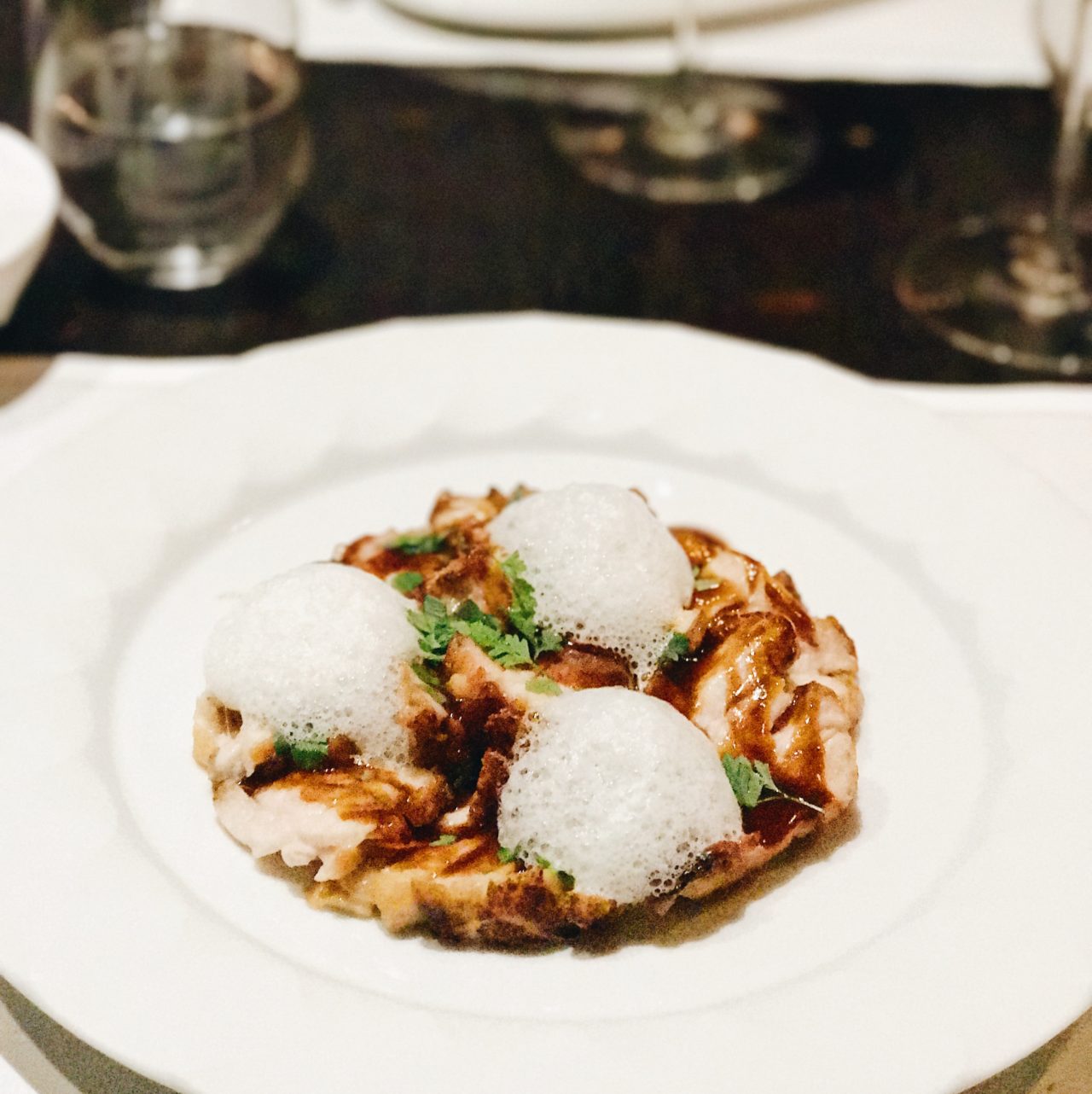 Paris restaurant Hexagone, egg appetizer prepared like a blancmange, the white served whipped with oozing yolk, black truffle slivers and celery cream