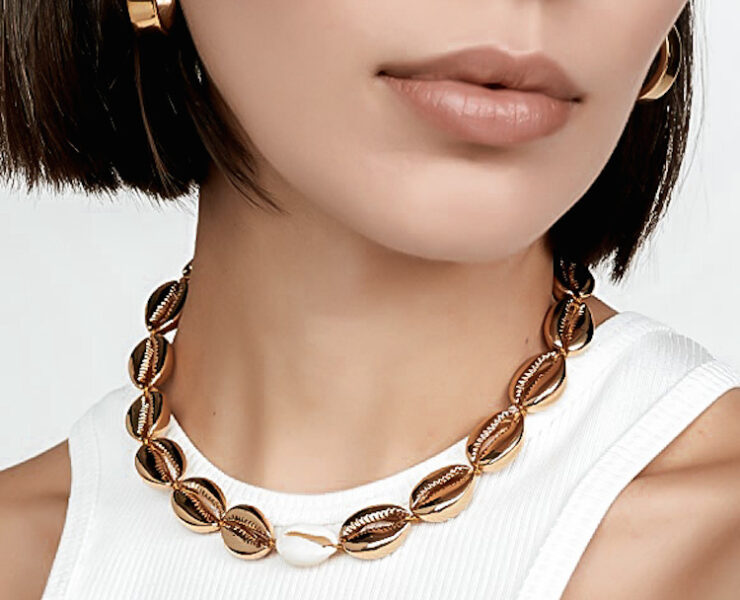 woman in luxe gold puka shell necklace