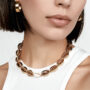 woman in luxe gold puka shell necklace